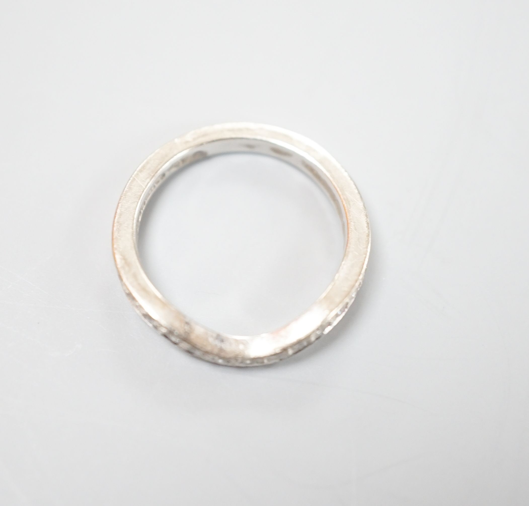 A modern 18ct white gold and diamond set shaped half eternity ring, size H/I, gross weight 3.3 grams.